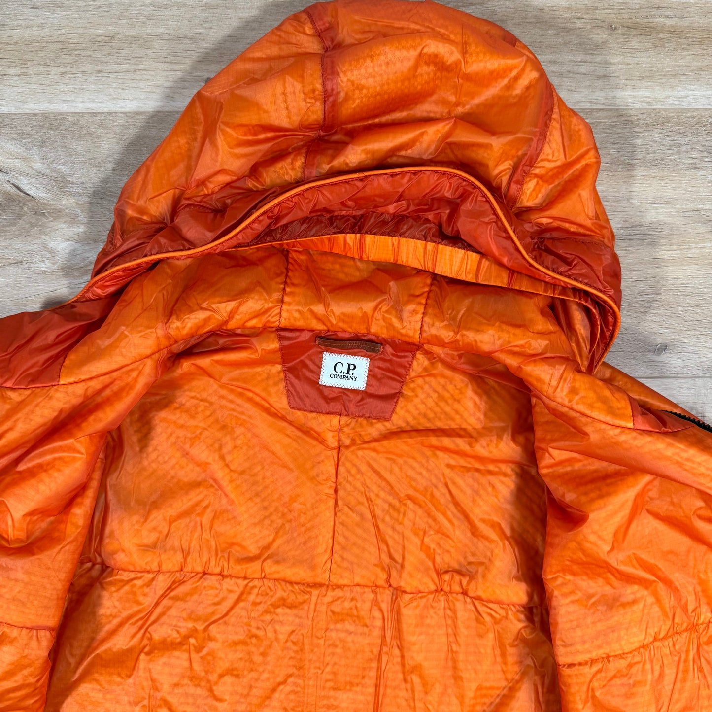 C.P. Company Nada Shell Lens Padded Jacket in Russet Orange