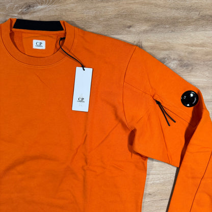 C.P. Company Diagonal Raised Fleece Crewneck Lens Sweatshirt in Russet Orange