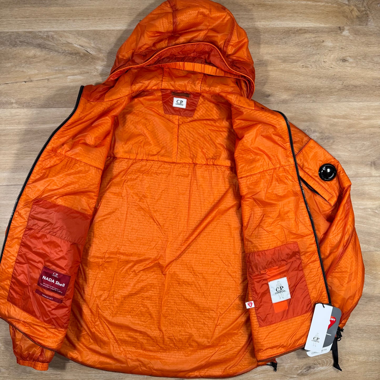 C.P. Company Nada Shell Lens Padded Jacket in Russet Orange