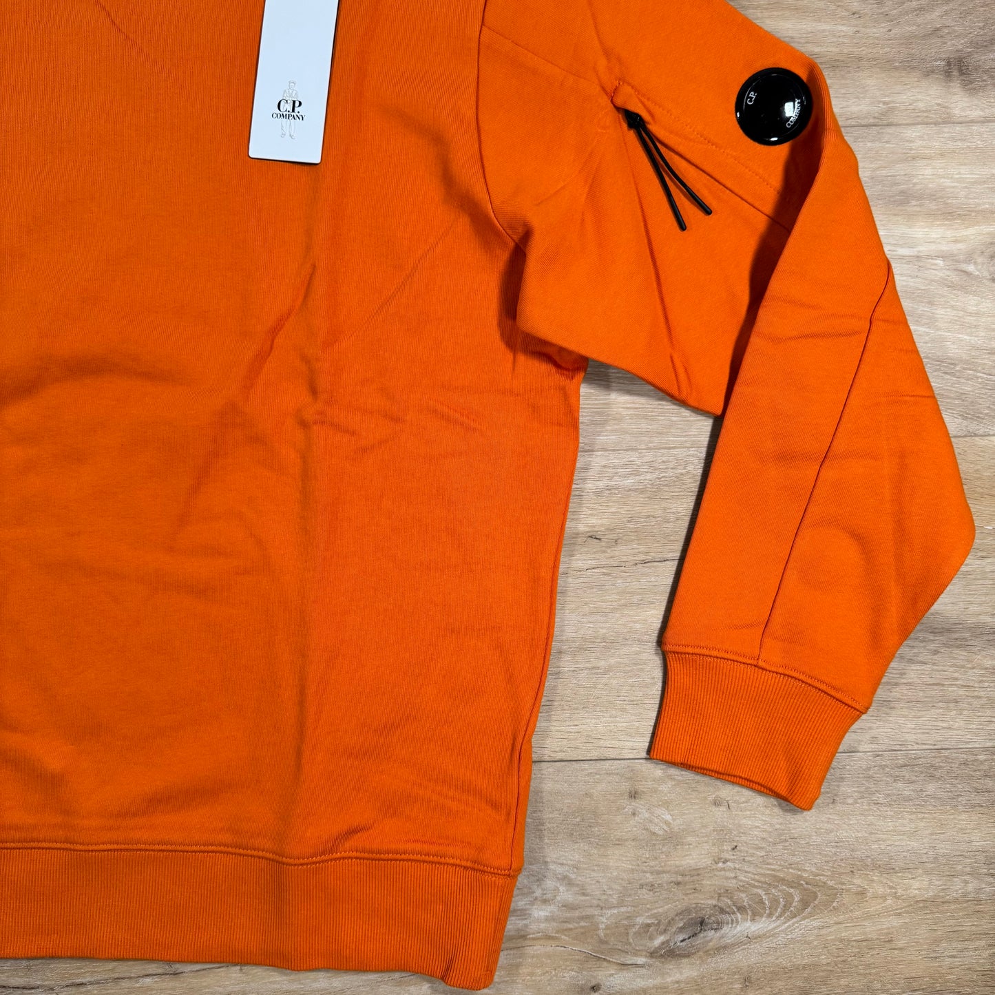 C.P. Company Diagonal Raised Fleece Crewneck Lens Sweatshirt in Russet Orange
