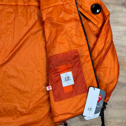 C.P. Company Nada Shell Lens Padded Jacket in Russet Orange