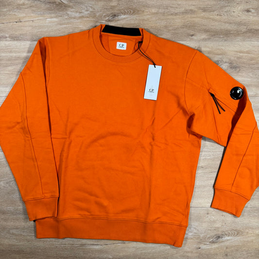 C.P. Company Diagonal Raised Fleece Crewneck Lens Sweatshirt in Russet Orange