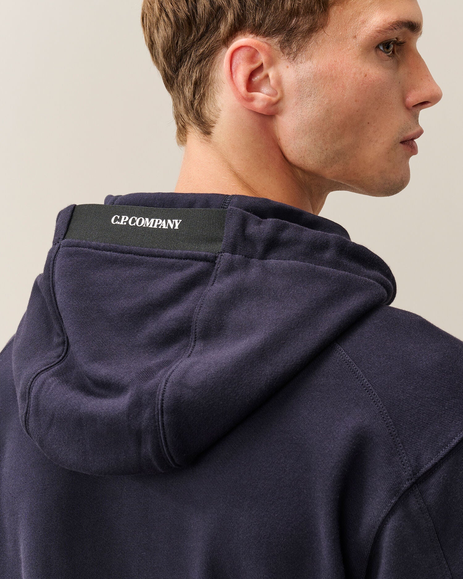 C.P. Company Diagonal Raised Fleece Lens Hoodie in Navy